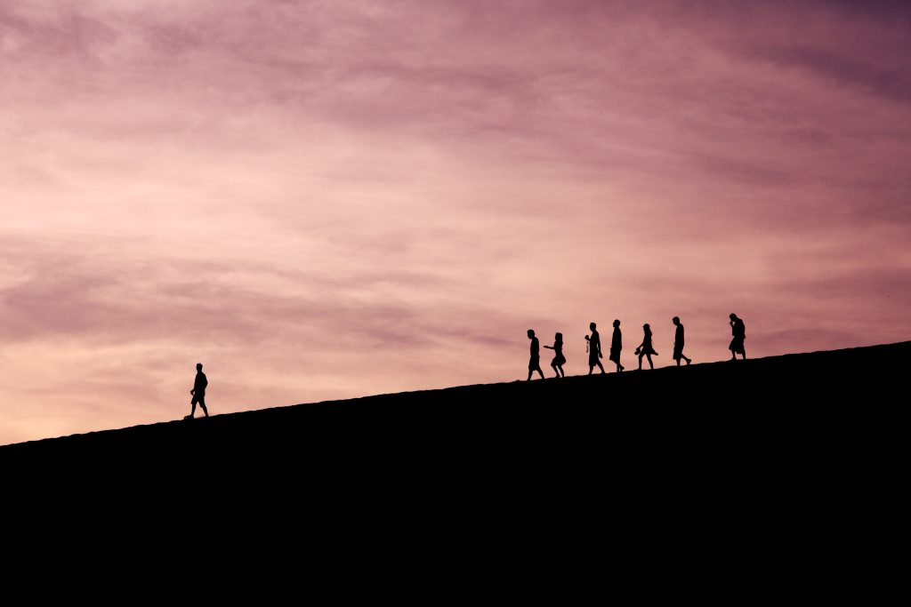 silhouette of people on hill